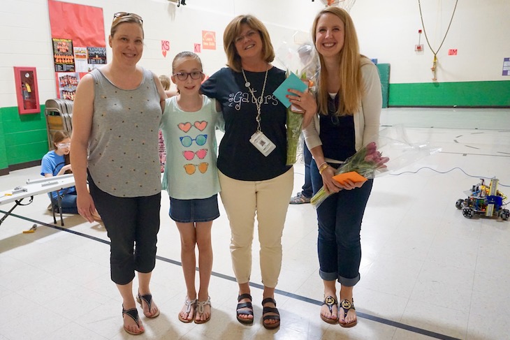 <p>BPS101 Enrichment Coach Julie Allen (second from right) and RMS Assistant Principal Nicki Kitzmiller (far right) dreamed up the “Science Herstory Engineering” course for BPS101 girls. On the last day, some parents and students brought them flowers and cards. The 10-session course was obviously a hit!</p>
