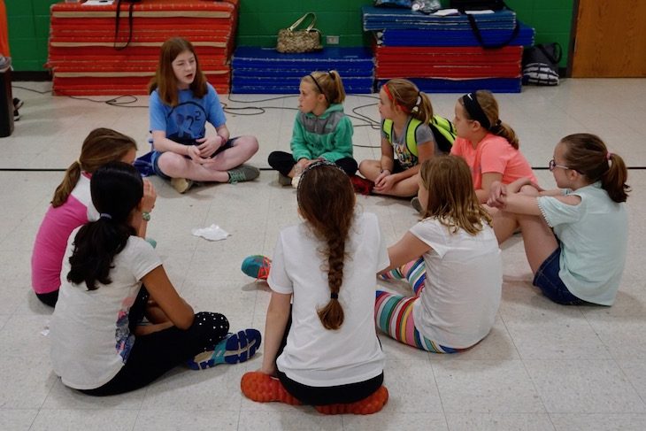 <p>Roaring Robotics team member/RMS eighth-grade student Kersten McQuillan leading a small-group discussion.</p>
