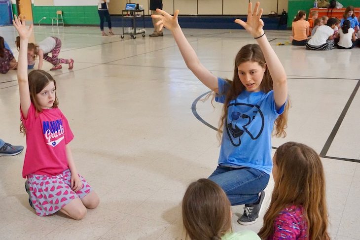 <p>BHS senior Ava Langstaff showing fourth-grade girls the tallest robot that she has built so far.</p>
