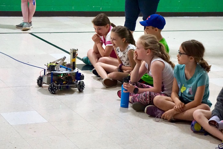 <p>Fourth-grade students watching Roaring Robotics’ mini robot in action.</p>
