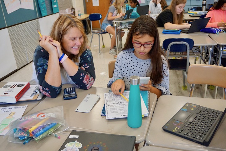 <p>RMS Math Teacher Heather Breon observing her student completing an assignment. </p>
