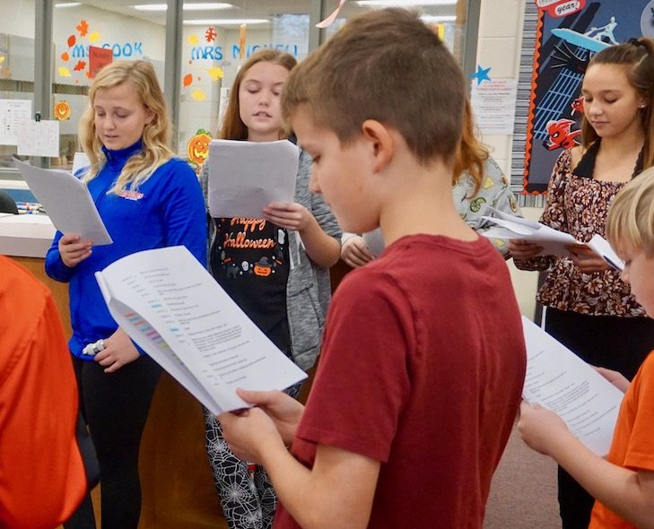 <p>Students read a “Legend of Sleepy Hollow” readers’ theater script in the RMS LRC to work on vocabularly, voice inflection, comprehension, and reading confidence.</p>
