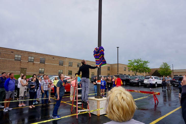 Mr. Holm unveiling his "Holm Place" sign by the parking spot he parked in for 37 years at RMS.